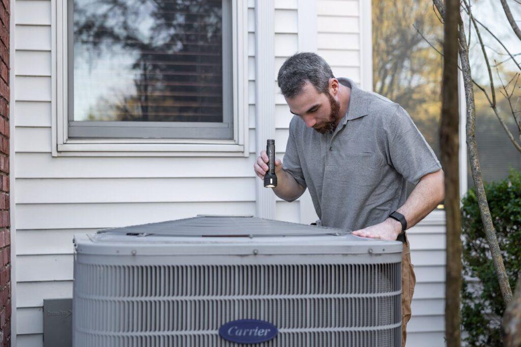 person checks HVAC system